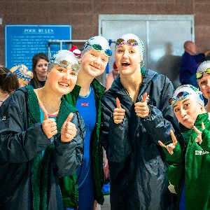 Swimmers give camera a thumbs up